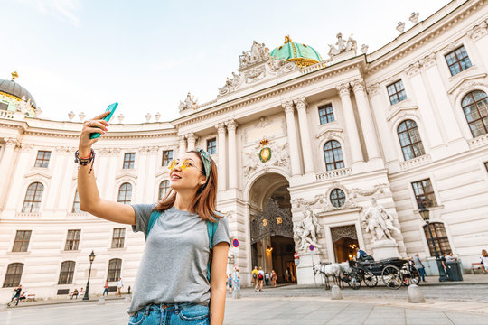 Young asian tourist taking selfie photo on her smartphone in Vienna, Austria