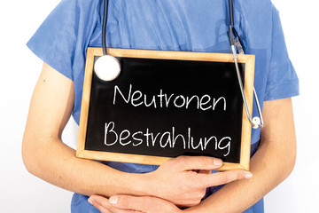 Doctor shows information on blackboard: neutronen bestrahlung.  Medical concept.