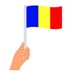 Flag of Romania. Hand holding a Romania flag - vector icon.