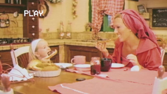 A fake retro VHS shot: precious bonding time for a 4-years-old little girl and her mother, having breakfast around the kitchen's table.