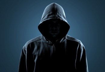 Thief in black clothes on grey background