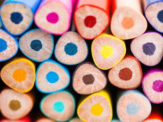 Ends of colorful watercolor pencils. School supplies background. Kid's stationery. Back to school macro backdrop.