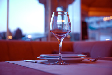 Selective focus. Empty glasses set in restaurant . Closeup image of empty glass ar blurred restaurant background. Close up picture of empty glasses in restaurant.