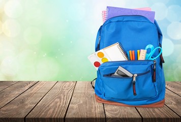 School bag on wooden  background.