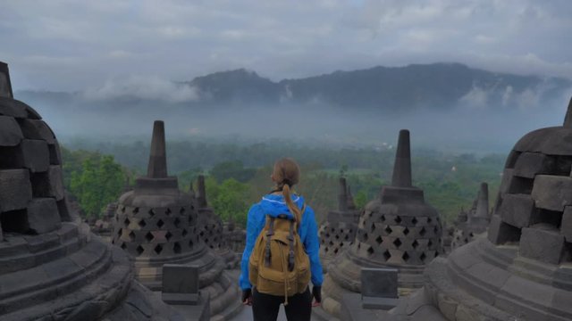 ourist backpacker exploring the Borobudur temple in Java island,Indonesia