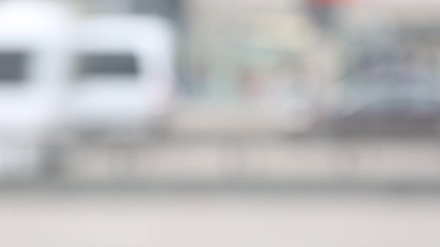 Many cars go on the highway. Out of focus. Traffic on the highway. 