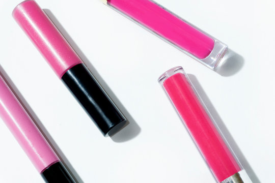 neon vivid  pink lip gloss, fusia  on white background 
