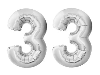 Number 33 thirty three made of silver inflatable balloons isolated on white background. Chrome...