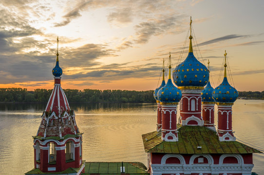 Uglich, Russia. Embankment of the Volga river in Uglich, the temple of Dmitry on Blood in the evening twilight, at sunset