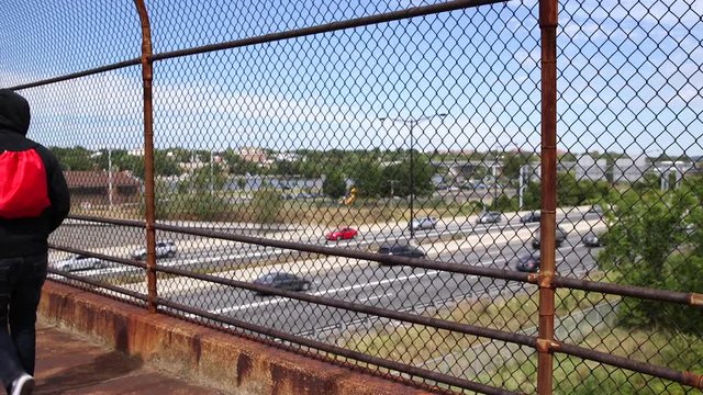 Man walks across Anacostia Bridge 295 CU