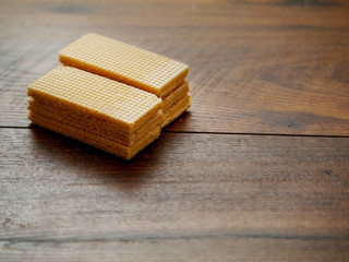 Dessert waffles on a wooden table, Close up. Copy space.