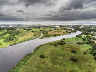 Fototapeta na wymiar Aerial view on River Corrib, Galway city and bay, Burren mountains in the background, Cloudy sky.