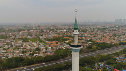 aerial view minaret mosque Al Akbar against city Surabaya highway, skyscrapers, buildings and houses. mosque in Indonesia Al Akbar in Surabaya, Indonesia. beautiful mosque with minarets on island Java