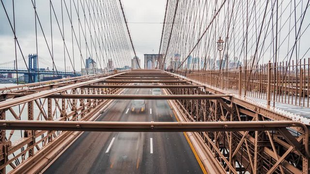 Beautiful time lapse view of the Brooklyn Bridge in motion. Cars and people passing the bridge from Manhattan island to Brooklyn. 