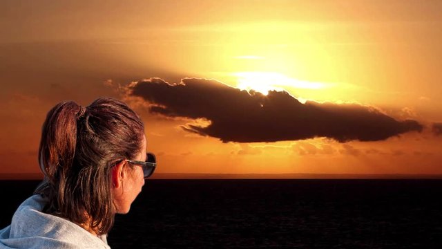 Cinemagraph sea sunset wallpaper with girl watching the sunset and awesome cloudy sky