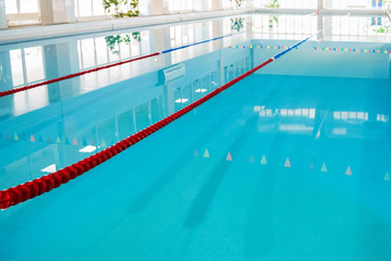 View of indoors swimming pool lanes with clean water