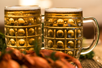Boiled crayfish with beer on wooden background