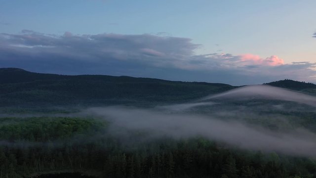 Blanket of fog over dense forest Sunset Aerial 4K