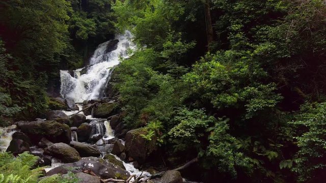 Torc waterfalls cascading slow motion down rocky waterway. Killarney National Park