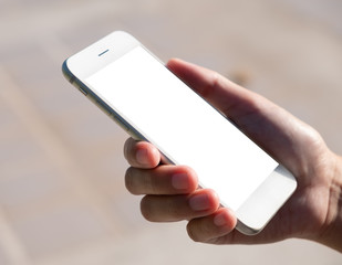 Woman hand holding and using smart phone with blank screen at outdoor background