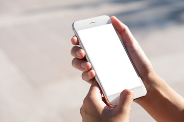 Woman hand holding and using smart phone with blank screen