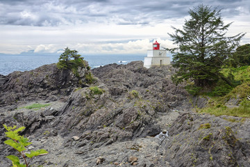 Scenic view of the lighthouse on the Pacific coast on a background of picturesque clouds on a summer day, Wild Pacific Trail, Ucluelet, BC, Canada Vancouver Island