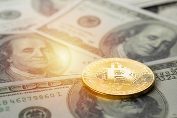 bitcoin golden coin on US dollar banknote background