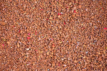 Volcanic gravel pebbles material, empty backdrop or background space.