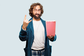 young man wearing bathrobe night suit with popcorns bucket