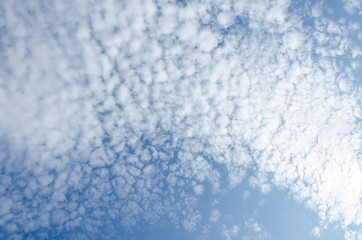 Beautiful cumulus clouds on a blue sky on a sunny day.