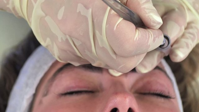 Young girl doing microblading procedure