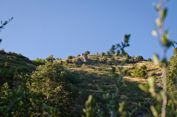 Fototapeta na wymiar The rock style hut on the top of the utah hillside in summer. 