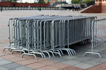 Grey metal fence folded in the street