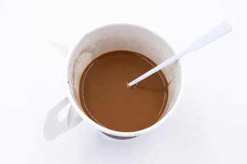 Top view of a paper cup of coffee on white background