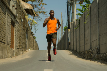 urban runner workout . Young attractive and athletic black afro American man running outdoors on...