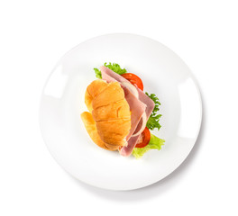 Big croissant with green salad and pork meat on isolate white background. Tasty croissant Food photo. Healthy food concept.