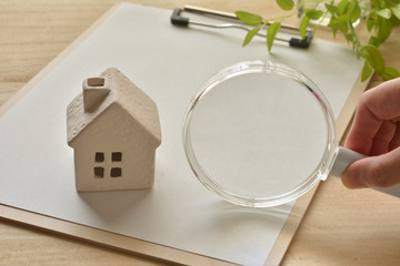Magnifying glass and house