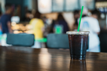 Cup of coffee ice americano on wooden table in coffee shop 