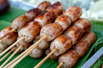 Grilled Thai sausage at street food market in Thailand. Traditional Thai sausage with pork and rice, delicious street food.