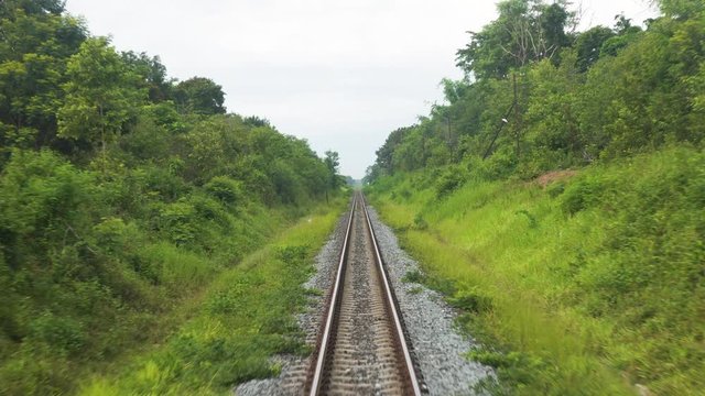 Train moving slowly through a rural landscape, shot from the front of a moving train, POV SHOT