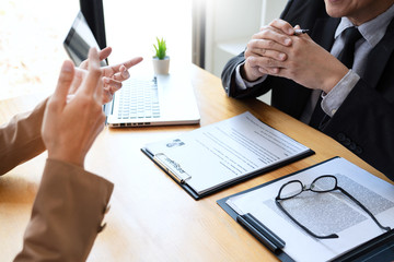 businessman candidate explaining about his profile and conducting a job to managers sitting in job Interview in modern office, consulting or employment concept.