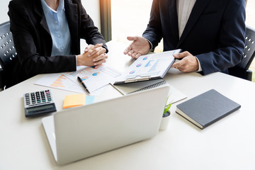 Business People Talking Discussing with coworker planning analyzing financial document data charts and graphs in Meeting and  successful teamwork Concept.