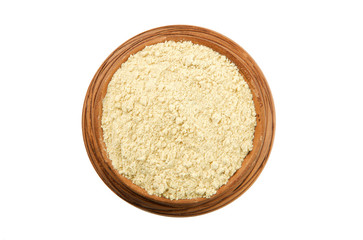 Ginger powder in a glossy cup isolated on white background. View from above. Seasoning on isolate. Dry spices.