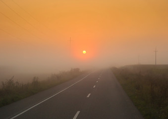 sunset light in fog. road trip, transportation concept