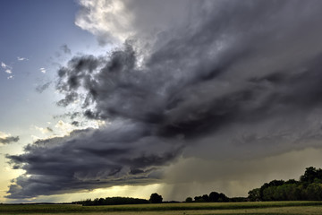 Big summer rainy cloud over countryside, somewhere in France.