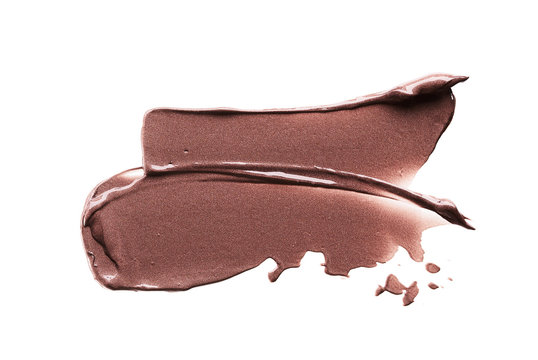 Brown strokes and texture of cream eyeshadow or acrylic paint isolated on white background