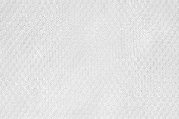 White fabric sport clothing football jersey with air mesh texture background. Seamless pattern of...