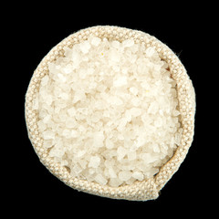 Salt in a bag isolated on a black background. View from above. Salt on isolate.