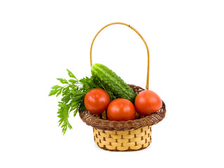 Tomatoes and cucumbers in a basket on a white background