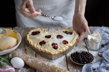 Obraz na płótnie Canvas Cooking cherry pie. Work with the test